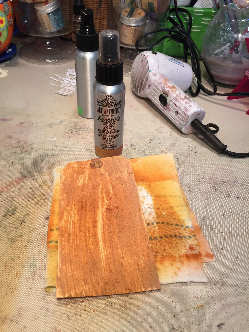 Next spray Glorious onto your tag, rubbing lightly to remove it from the painted areas.