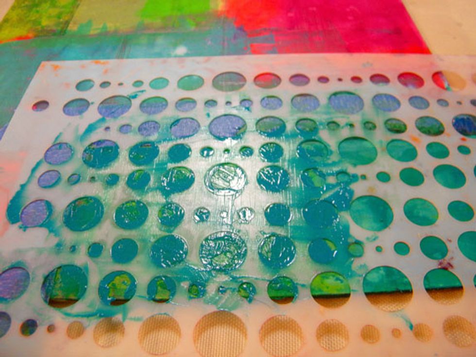 Next start adding stencils to the layers. I used Baby Blue Eyes with the Bubble stencil over one of the green boxes.