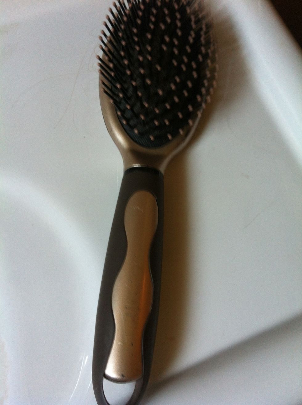 Next start to brush your hair. If you have a tender scalp, grab the strands of hair that you are brushing and hold them by the roots/or your scalp.