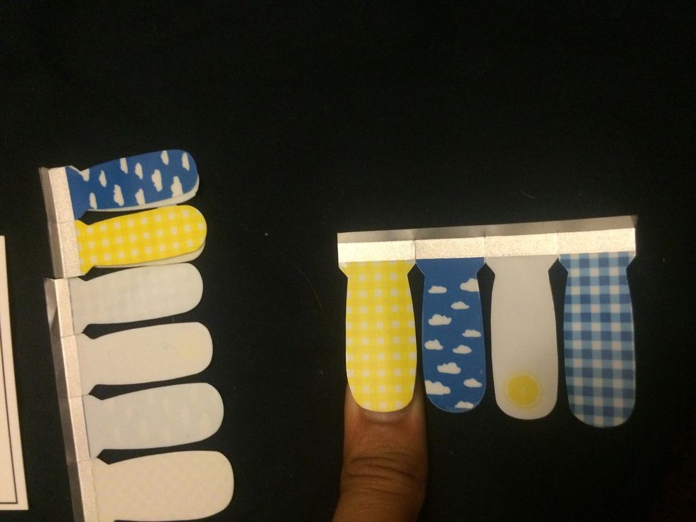 Next step is finding the right sizes. Put the sticker up against your finger nails and check the fit. Don't worry if they're slightly bigger on the sides, they can be filed down later.