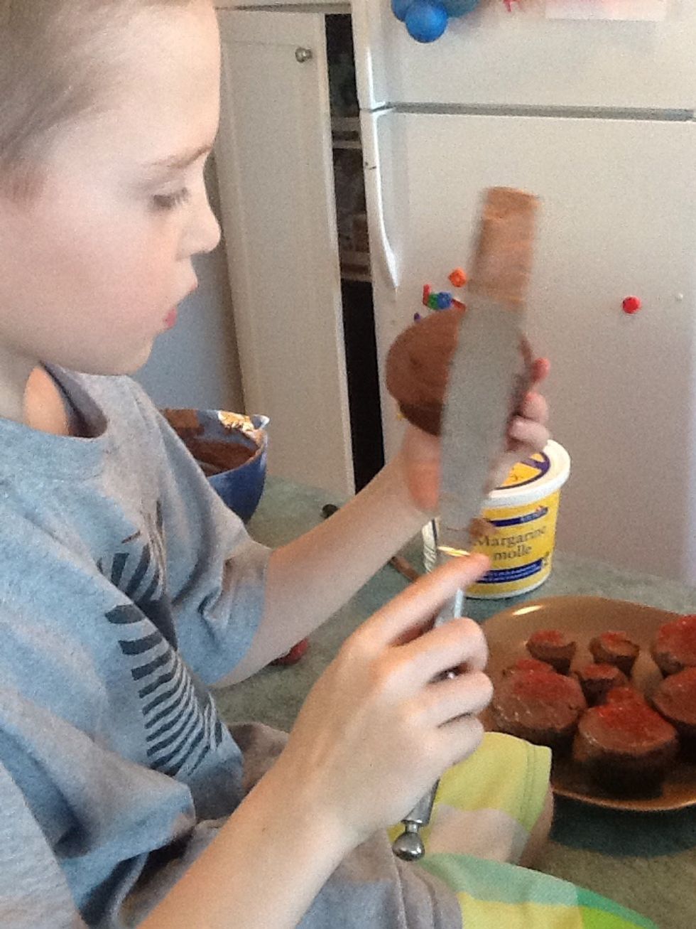 Next step. Put the yummy icing on the cupcakes.