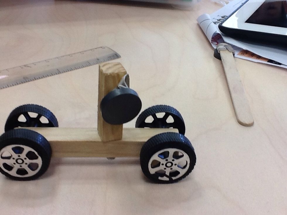 Next,stuck the shorter piece of wood on the nail,use dubble Side tape to stick the magnet on the shorter piece of wood.