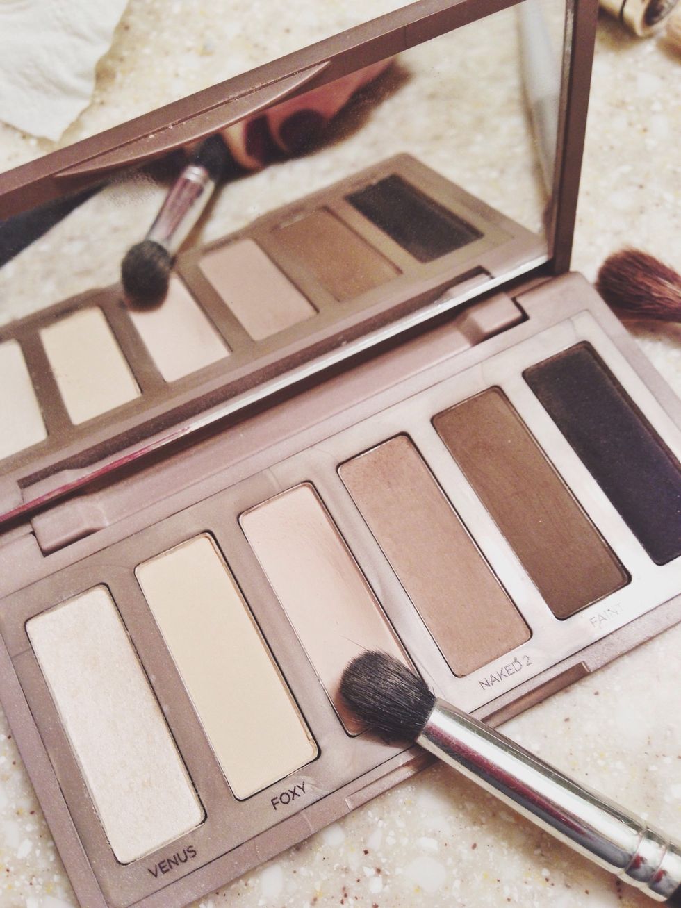 Next take a medium sized brush, and using the W.O.S., color cover your entire eyelid blending underneath your brow bone all the way to your lash line.