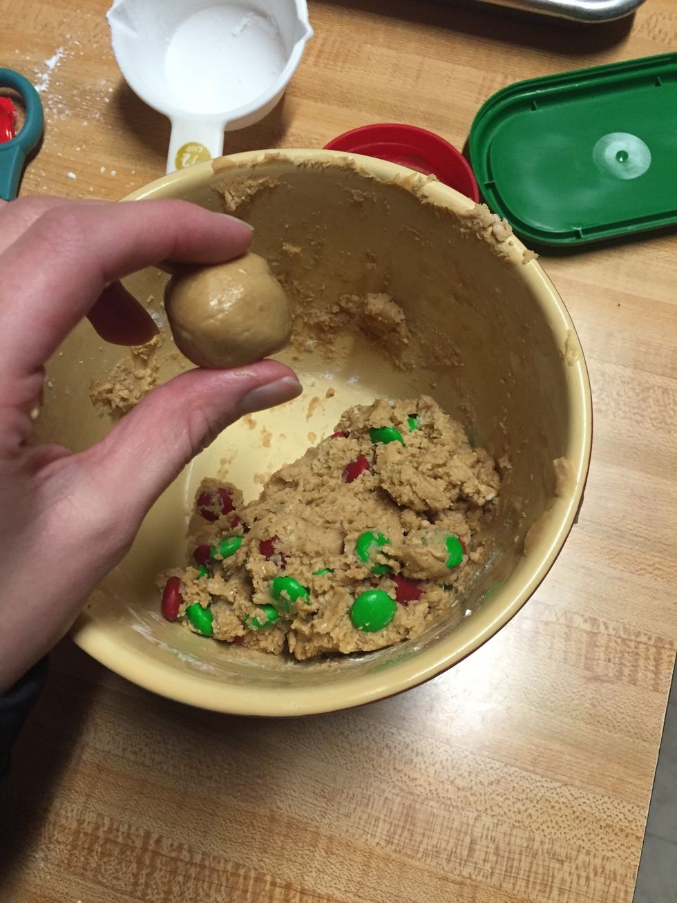 Next, take some of the mix and roll it into a small ball. Place them on the cooking sheet.