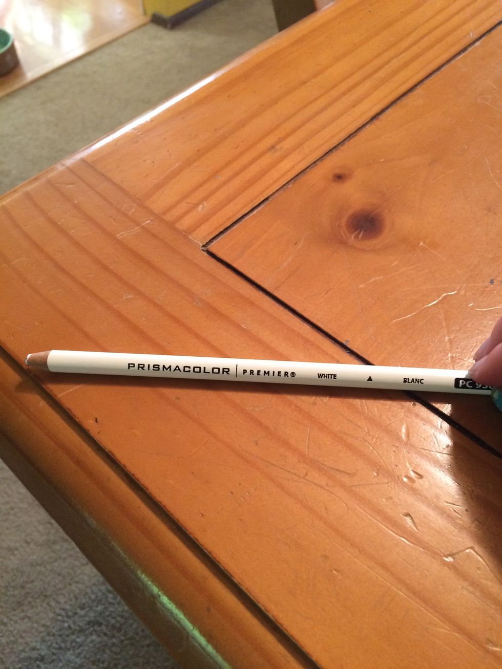 Next take the white colored pencil