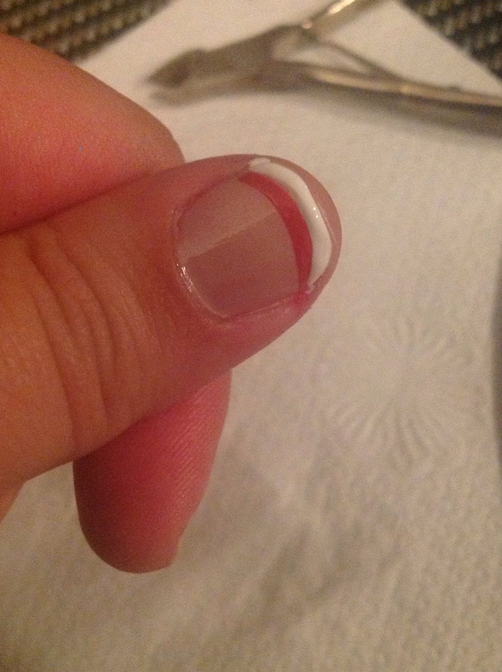 Next, take the white polish & make the traditional white curved line at the edge of your nail. A tip for keeping steady: lean the hand that your painting on, onto a table or surface.