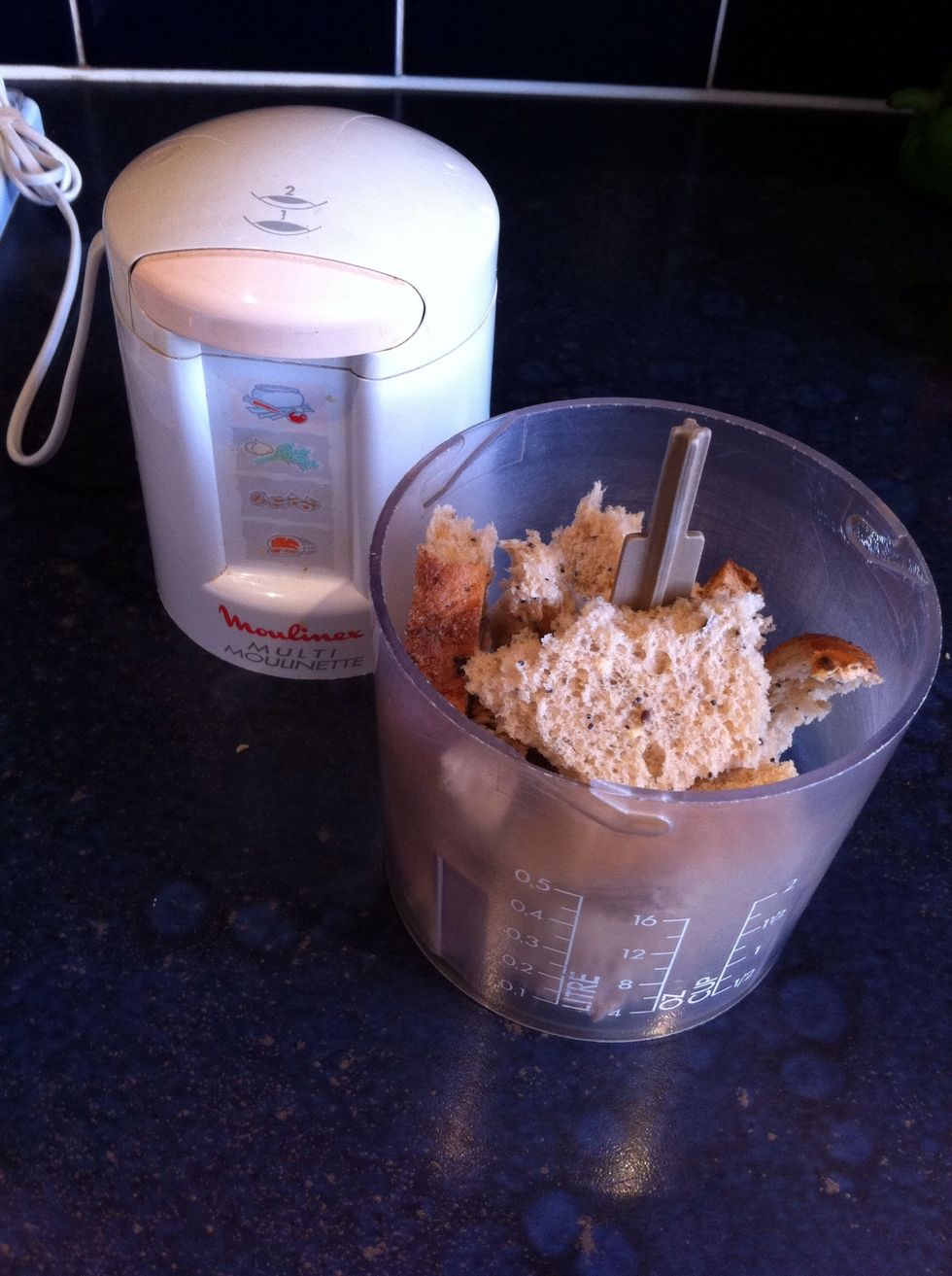 Next take your 2 slices of bread and put them in a blender to make bread crumbs. They should be finely chopped with no big pieces left inside