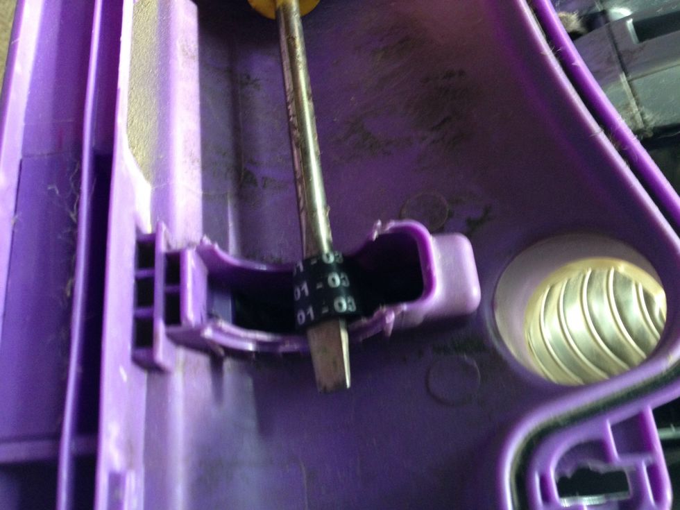 Next take your flat head and fish out the smaller belt through the housing. You can also use the tool provided with the Belt Tool kit.