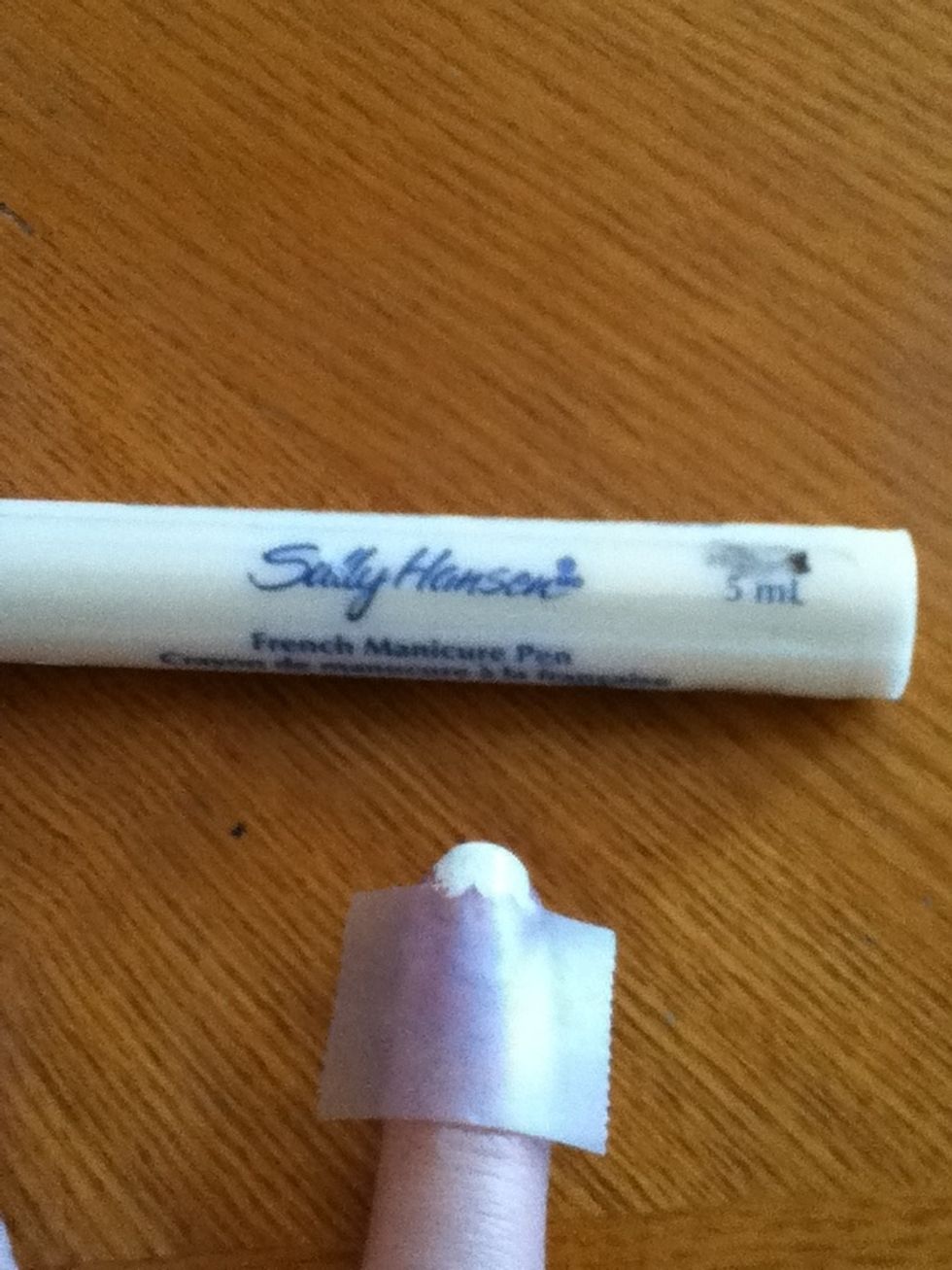 Next take your French manicure pen, and go over the top part of your nail.