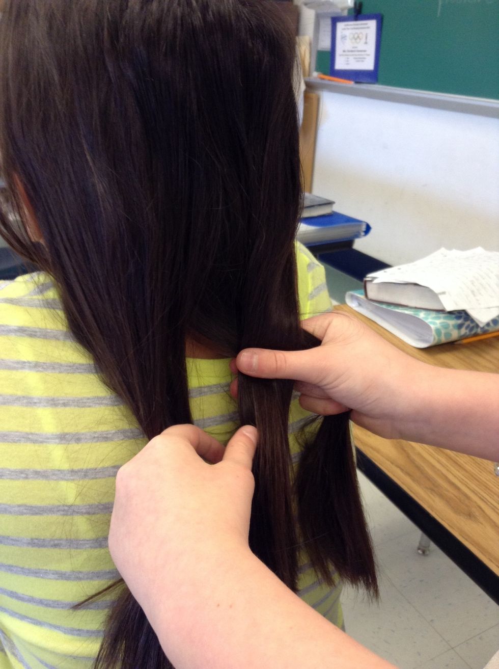 Next,take your right section of hair and switch it out with the middle.