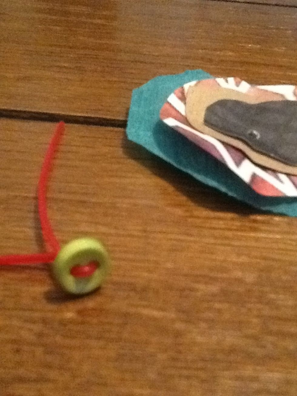 Next thread the cord or ribbon through the button