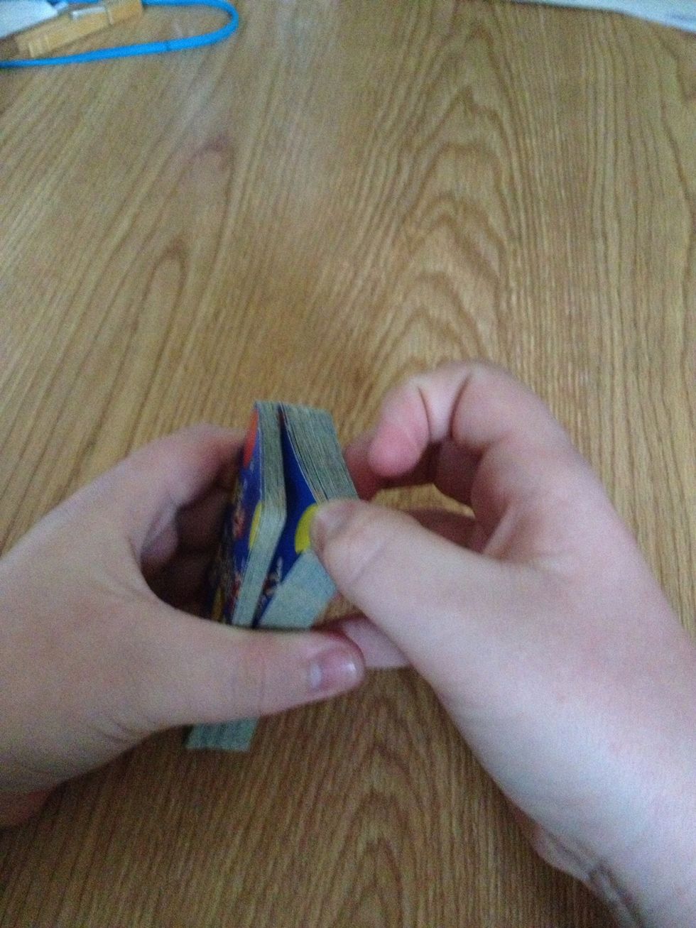 Next, to continue this trick, start to fan the cards starting at about one third of the way from the top of the deck. This spot is chosen so the next card picked is in the lower half of the deck.
