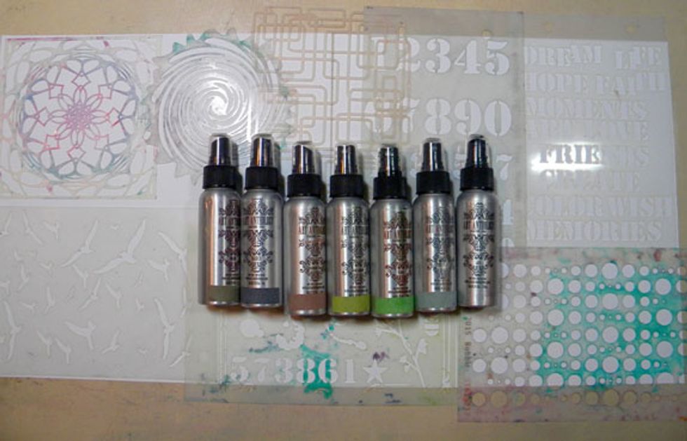 Next, to make my handmade patterned paper. I laid out two pieces of white cardstock and covered them with stencils. I chose a neutral color palette to keep the natural feel of the layout.