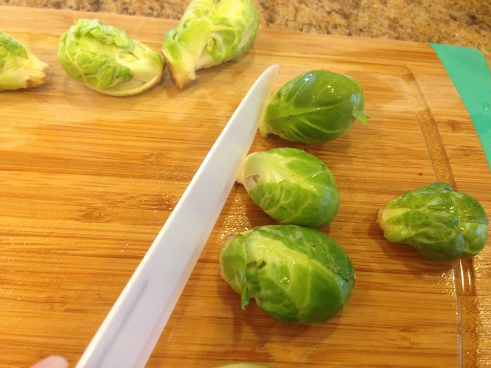 Next, trim off the bottom of the Brussels sprouts, being careful not to cut off too much or the Brussels sprout will fall apart.