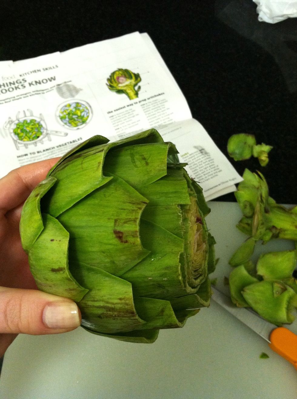 Next, trim the stem and peel off any blackened portions and snap off the small outer leaves around the bottom.  Use kitchen shears to trim the pointy tips from the remaining leaves.
