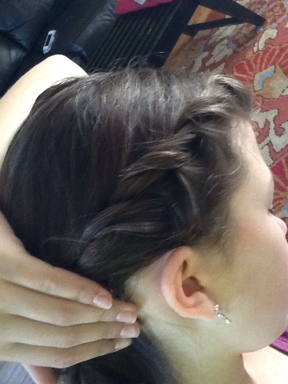 Next, twist those two pieces, but add a little bit of hair from the front each time.