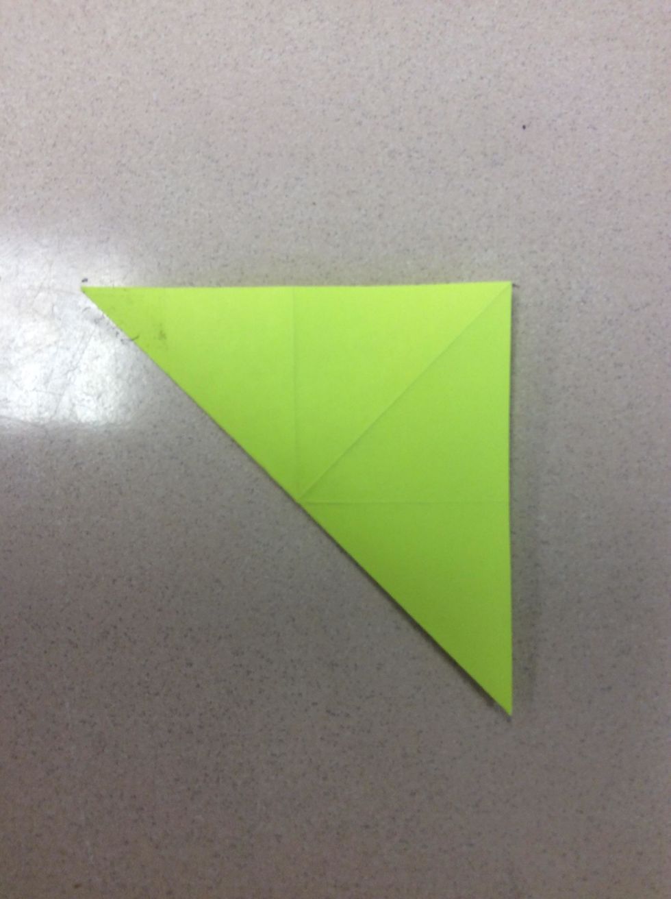 Next, unfold it, take the left bottom corner and fold it to the right top corner. It should look like this...
