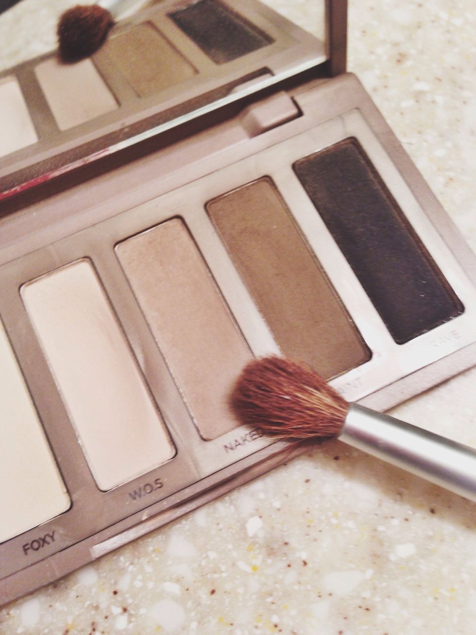 Next up use a fluffy brush that will fill your crease nicely. Using the Naked 2 color, cover your crease and out edge of eyelid. Then using the same brush darken the crease just a bit with Faint.