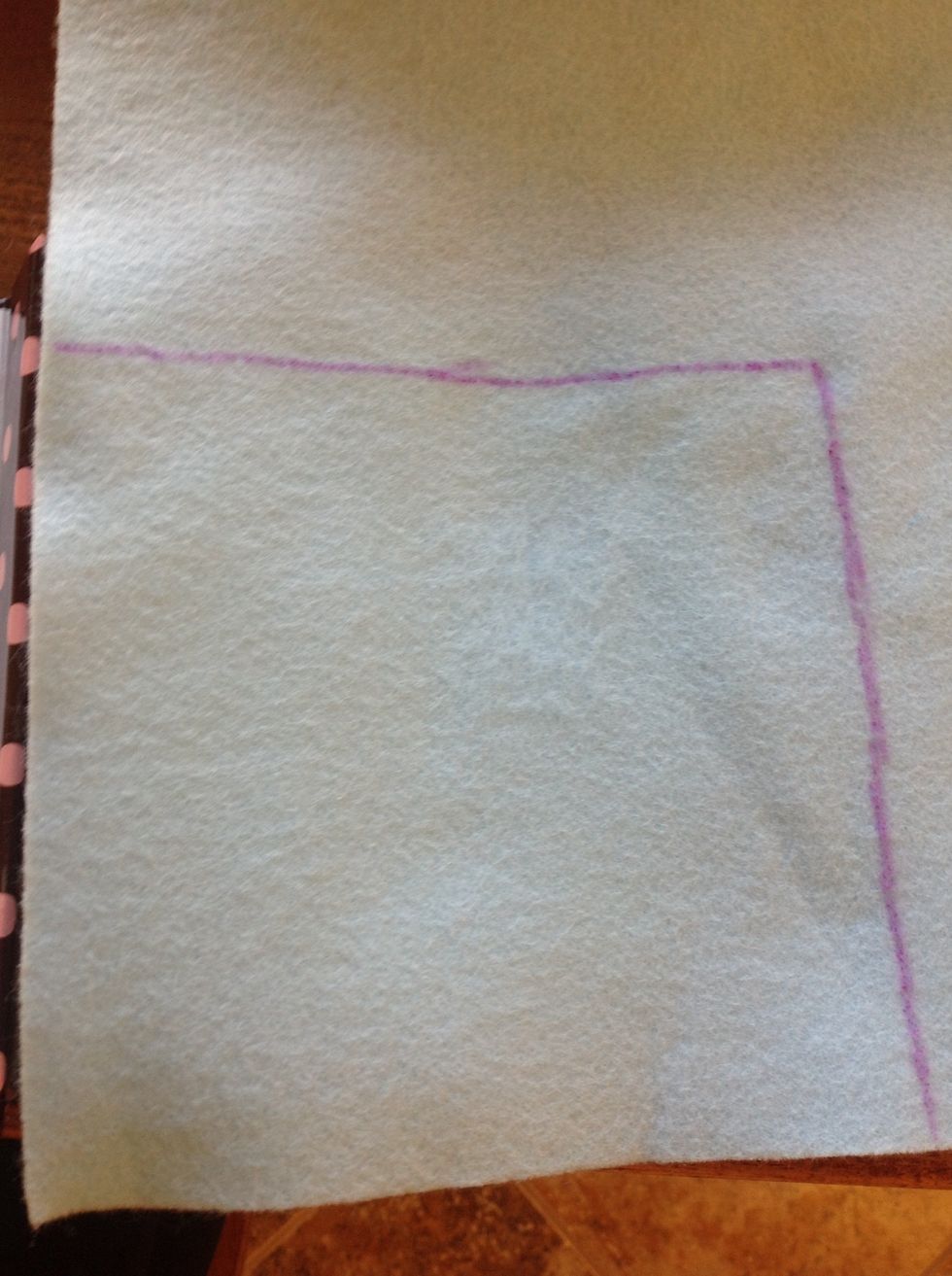 Next, use a fabric disappearing ink marker and trace the felt to that it fits on the page and cut out the felt using fabric scissors