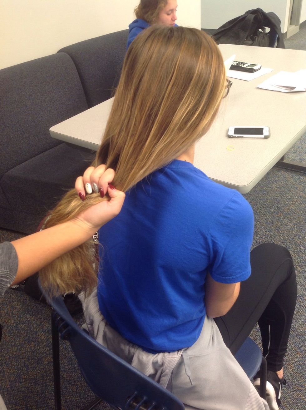 Next, use one hand to separate the hair into three even pieces. If the pieces aren't even, when you are done and ready to tie, it will fall out.