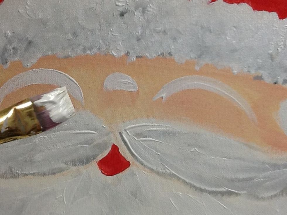 Next use the white paint to add a highlight to the nose and cheeks.