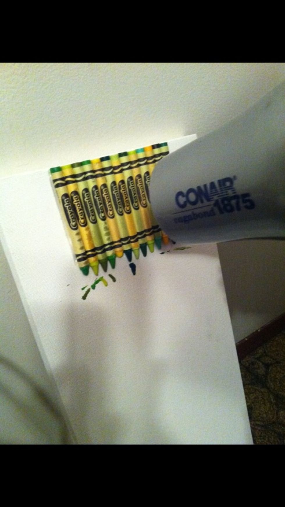 Next using a blow dryer on High heat, low air setting, start to blow dry the crayons so they melt!!!