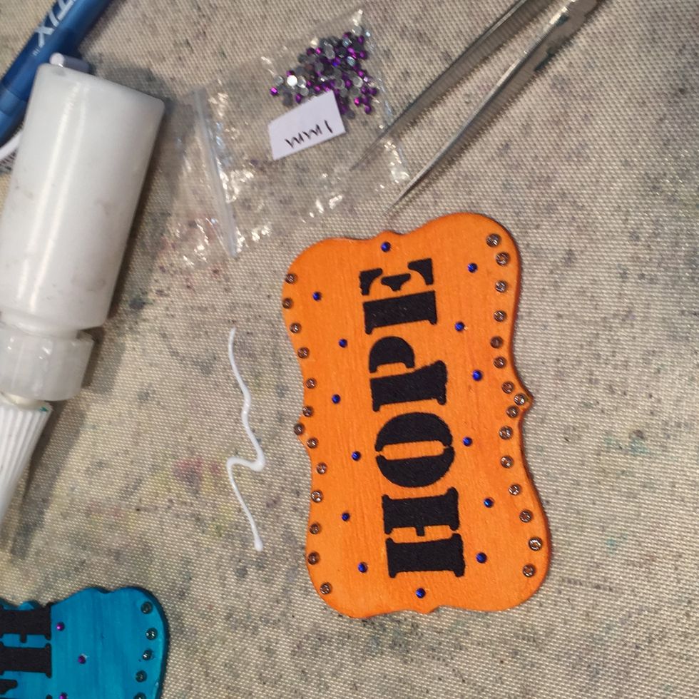 Next, using a little glue, add your flat-back rhinestones. My paint was dry by this point and I wanted to add a few extra embellishments.