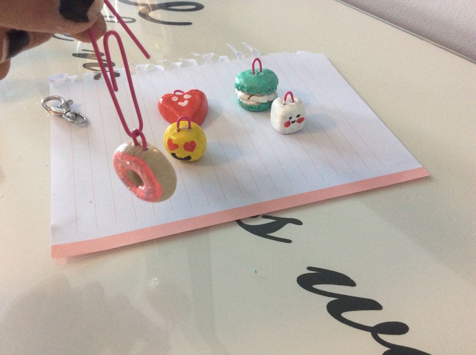 Next using a paper clip slide the loop of your clay design on to the paper clip
