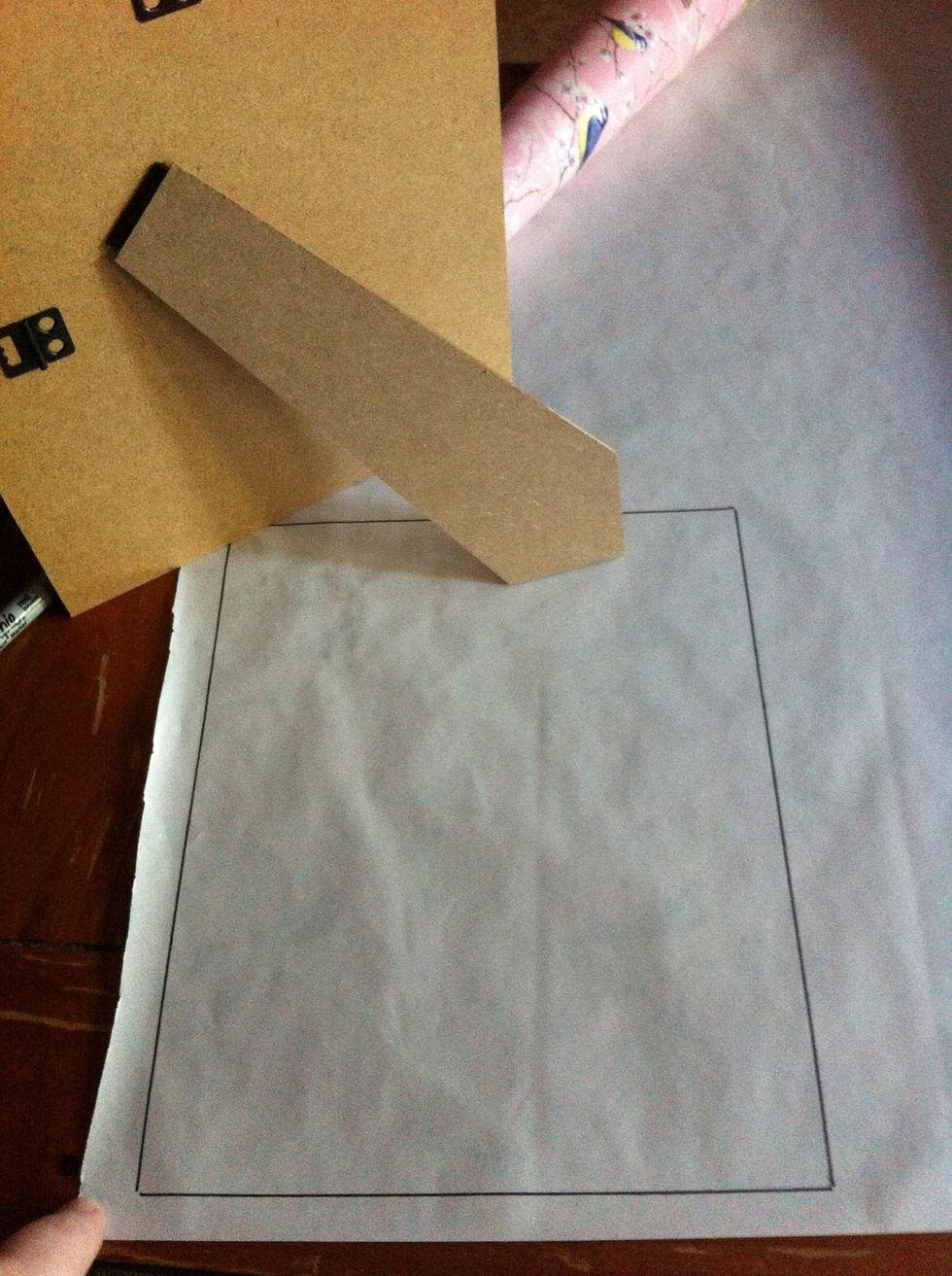 Next using a sharpie or pencil/pen trace around the photo frame board onto the paper