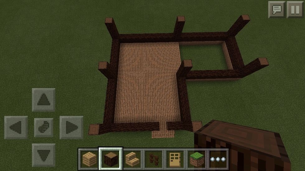 Next using spruce blocks again, I have outlined the outer parts of the shape. Place blocks on top of wooden plank. Remember to leave a one block hole around the stairs for he door!
