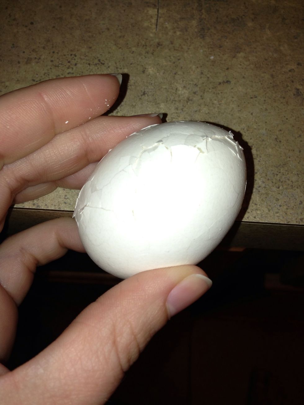 Next, using the edge of the counter, gently tap the egg several times. You want to put a crack on all sides of the egg.