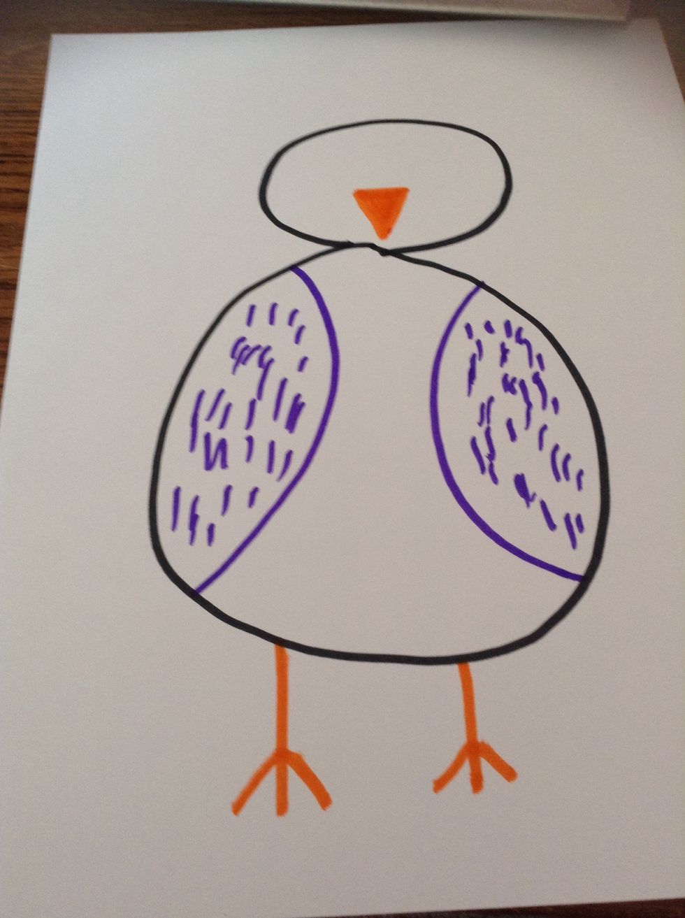 Next, using your orange or yellow marker, draw the feet and the beak.