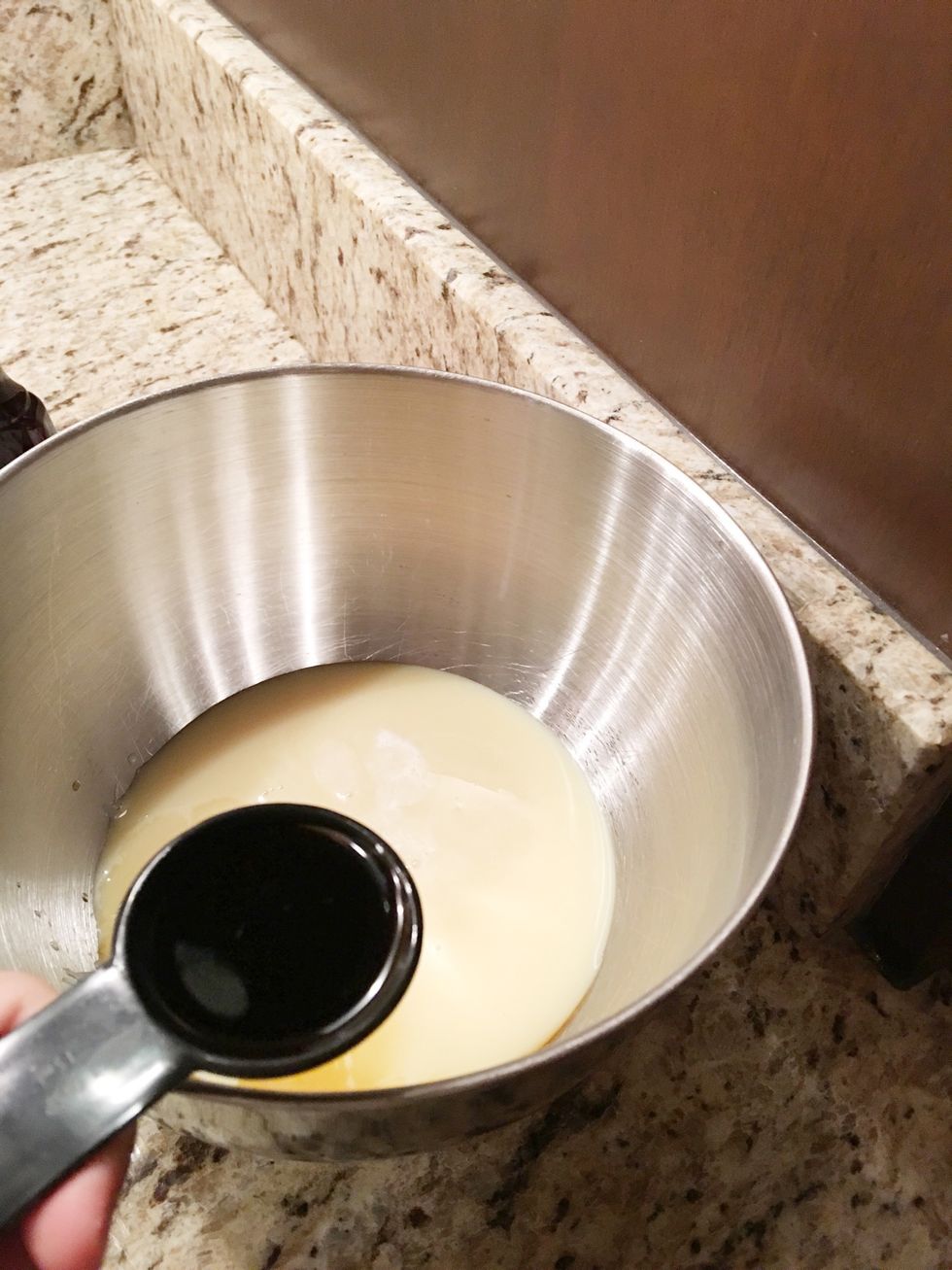 Next, using your other bowl, mix together your 14 ounce can of sweetened condensed milk, and your vanilla. You will need to use a can opener to open the milk. Measure the vanilla with a table spoon.