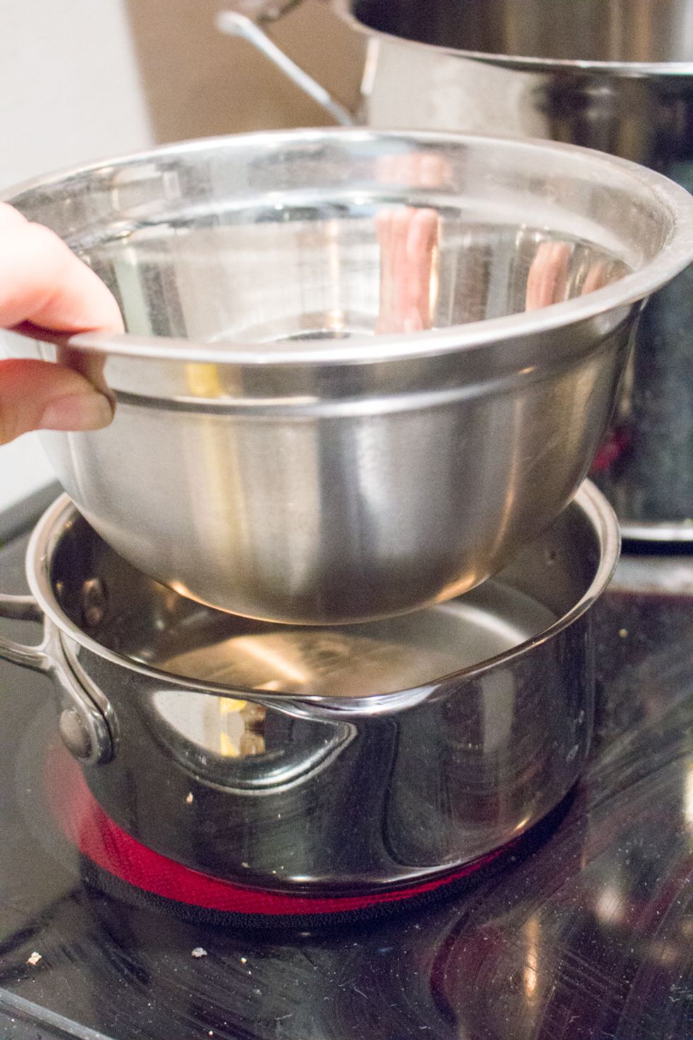 Next we are going to create the lemon curd. Setup a double boiler, which is water in a sauce pan and heat-proof bowl.