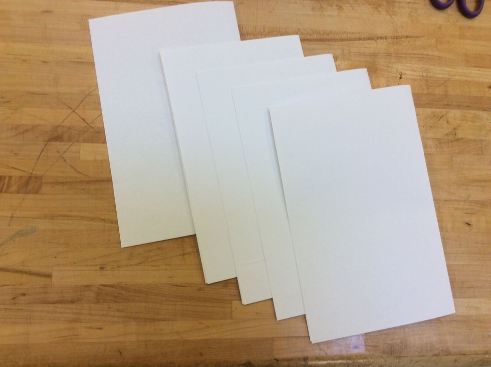 Next, we fold the rest of our paper in half (Hamburger Style).  Set one piece of folded paper to the side (you will use this in a later step to make the cover for your book).