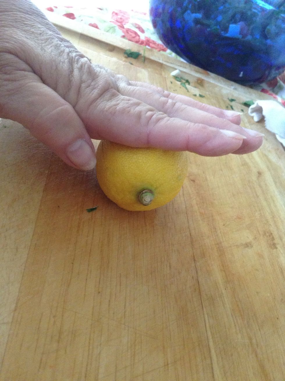 Next we're going to add lemon juice - roll and press the lemon before you cut it to get the maximum juice out of your lemon.