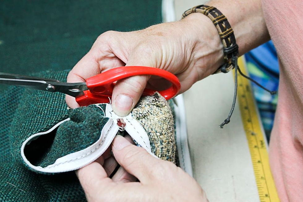 Next, we will remove the zipper.  Zip the slide up several inches so that you can work with it without the risk of it pulling off the teeth.  Whatever you do, don't let the slide pull off the end!