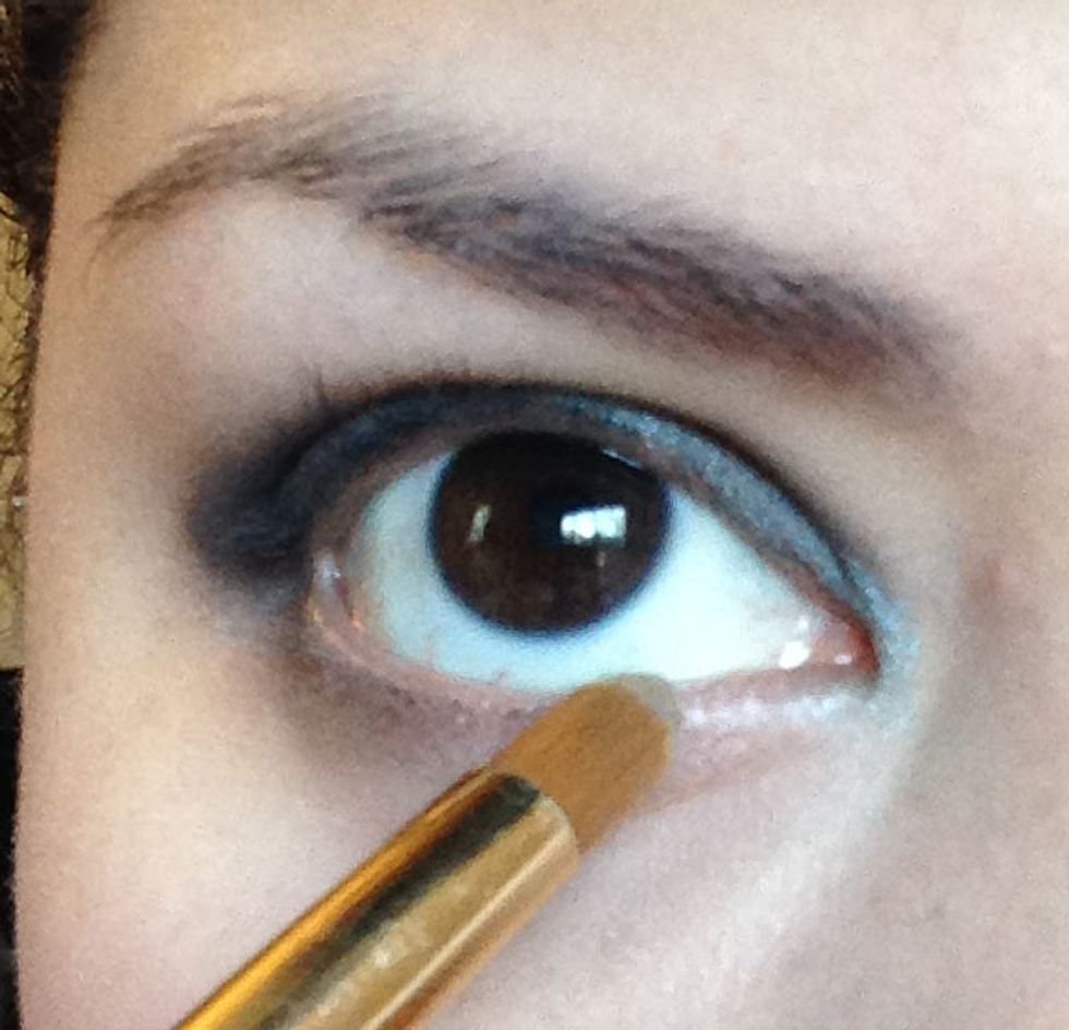 Next with a very small brush take the shade Luster (a deep taupe color) and apply to the lower lash line all over the bottom.