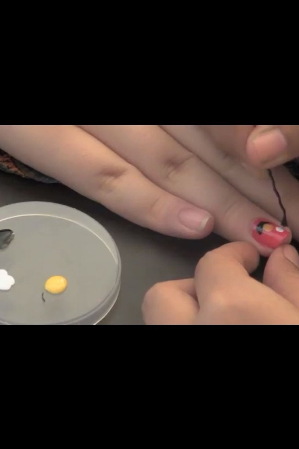 Next with the bobby pin and with white color make two circles, there were the eyes