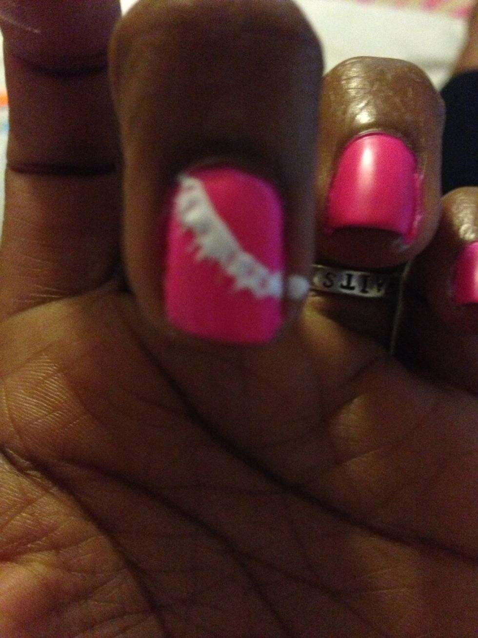 Next with the dotting tool make a half circle and so it won't dry quickly, use the straight pin at the top and drag the nail polish down to make a line.