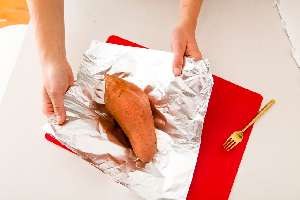 Next, wrap your sweet potato in tin foil and place it in the oven at 375 degrees Fahrenheit for 50-60 minutes, or until you can easily stick a fork in it.