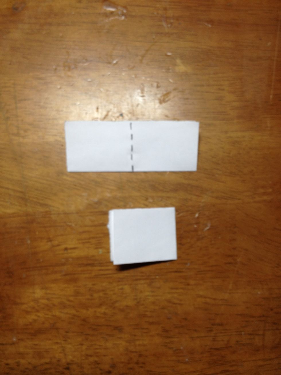 Next, you are going to fold the piece in half the other way, along the dotted line. (the bottom piece is why it should look like after it has been folded).