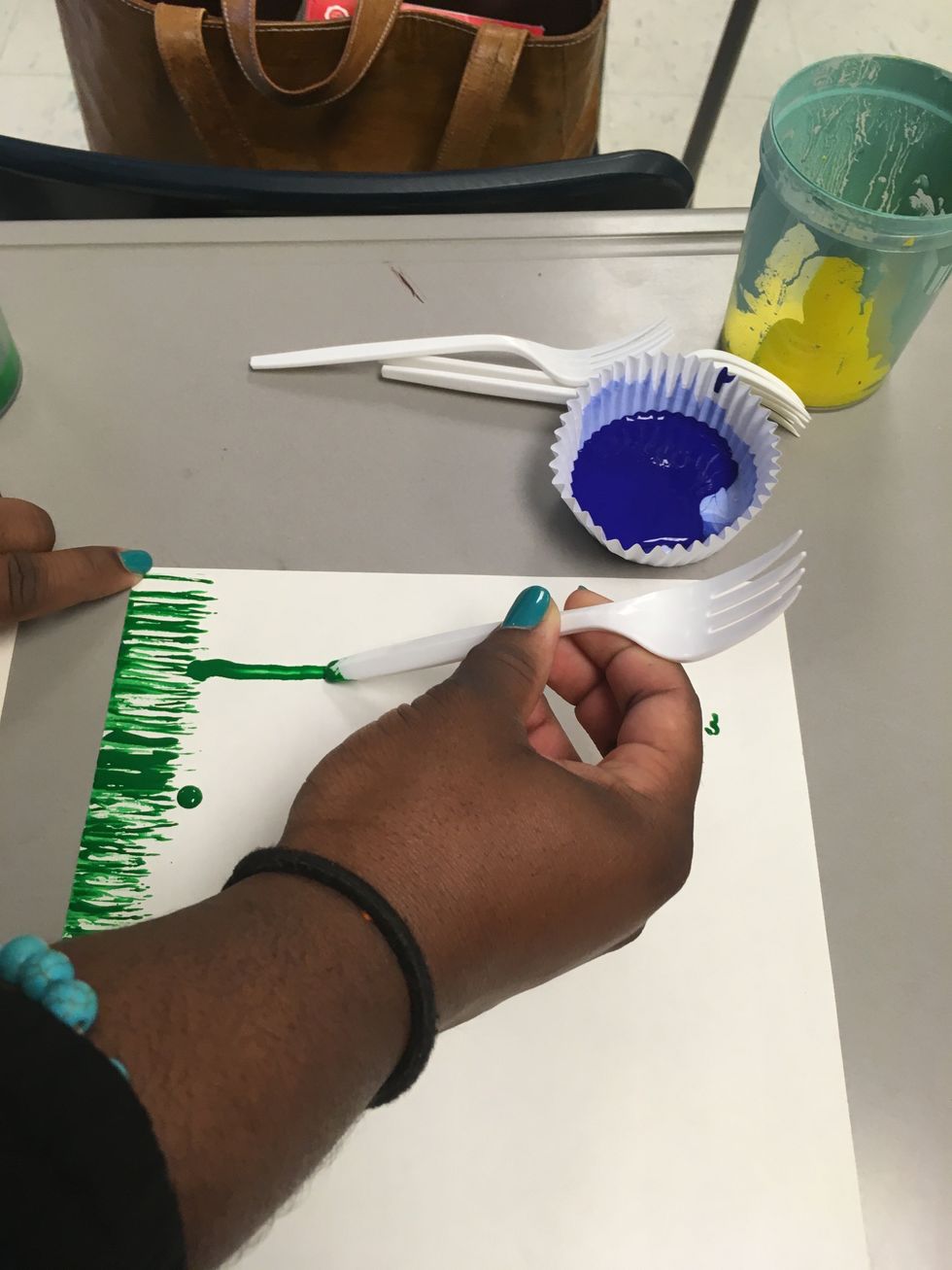 Next you draw the stem. Take the bottom of one fork and start at the top of the grass and slide it upwards.