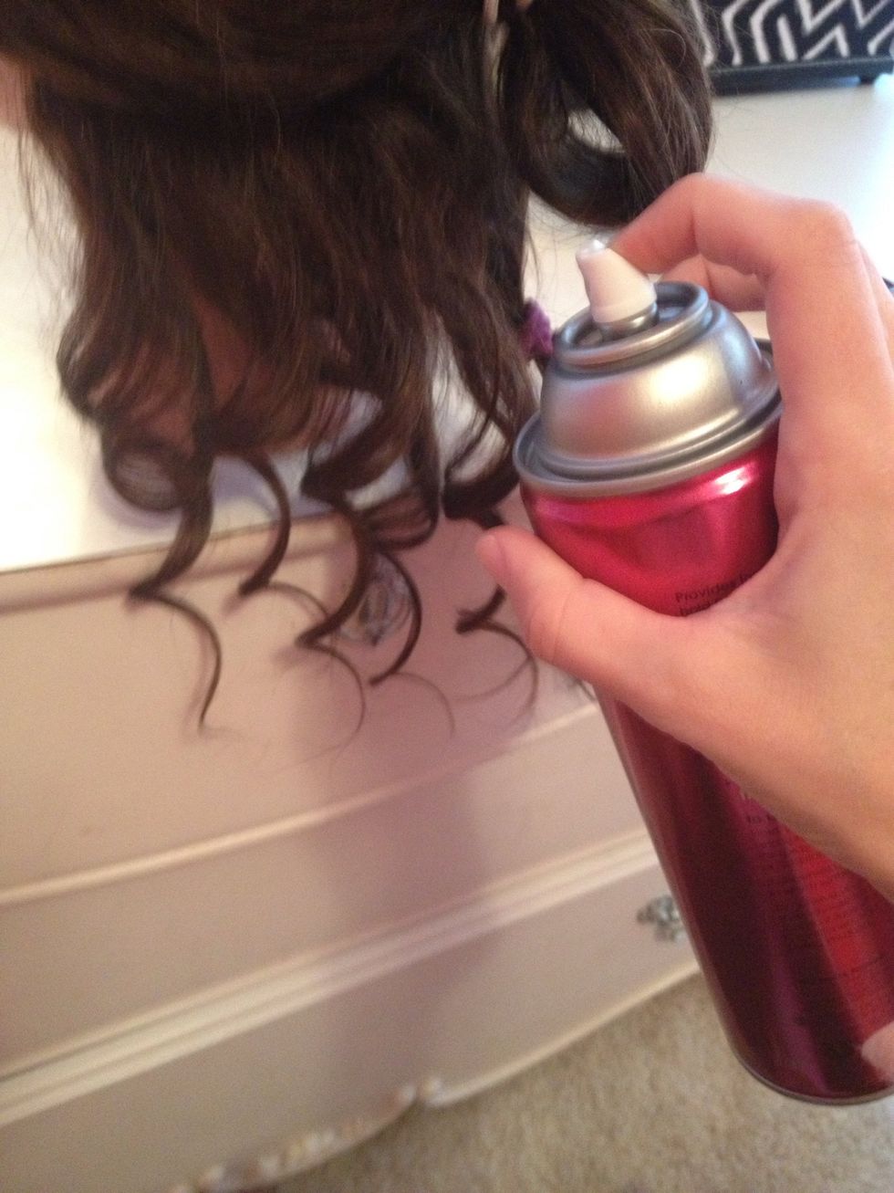 Next, you have to spray ONLY THE FIRST SECTION with hair spray.