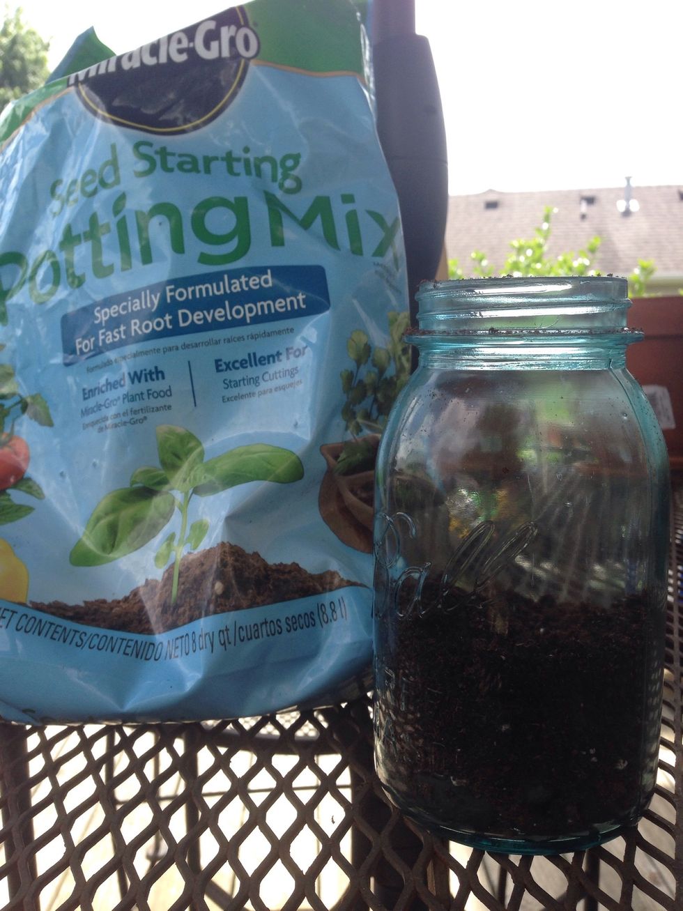 Next, you'll need to take soil or potting mix and layer it on top of the rocks, try not to mix the two together and keep the soil on top of the rocks. You need to make it the same depth as the rocks.