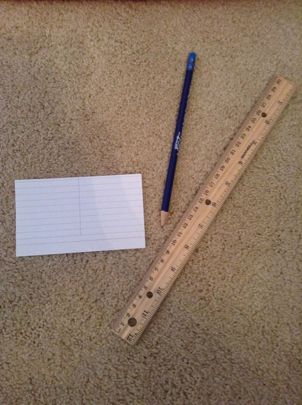 Next, you'll need your pencil, ruler, and one index card. With your ruler, mark a line in the middle of the card using the ruler as a straight edge. It should go to about one line before the red line.