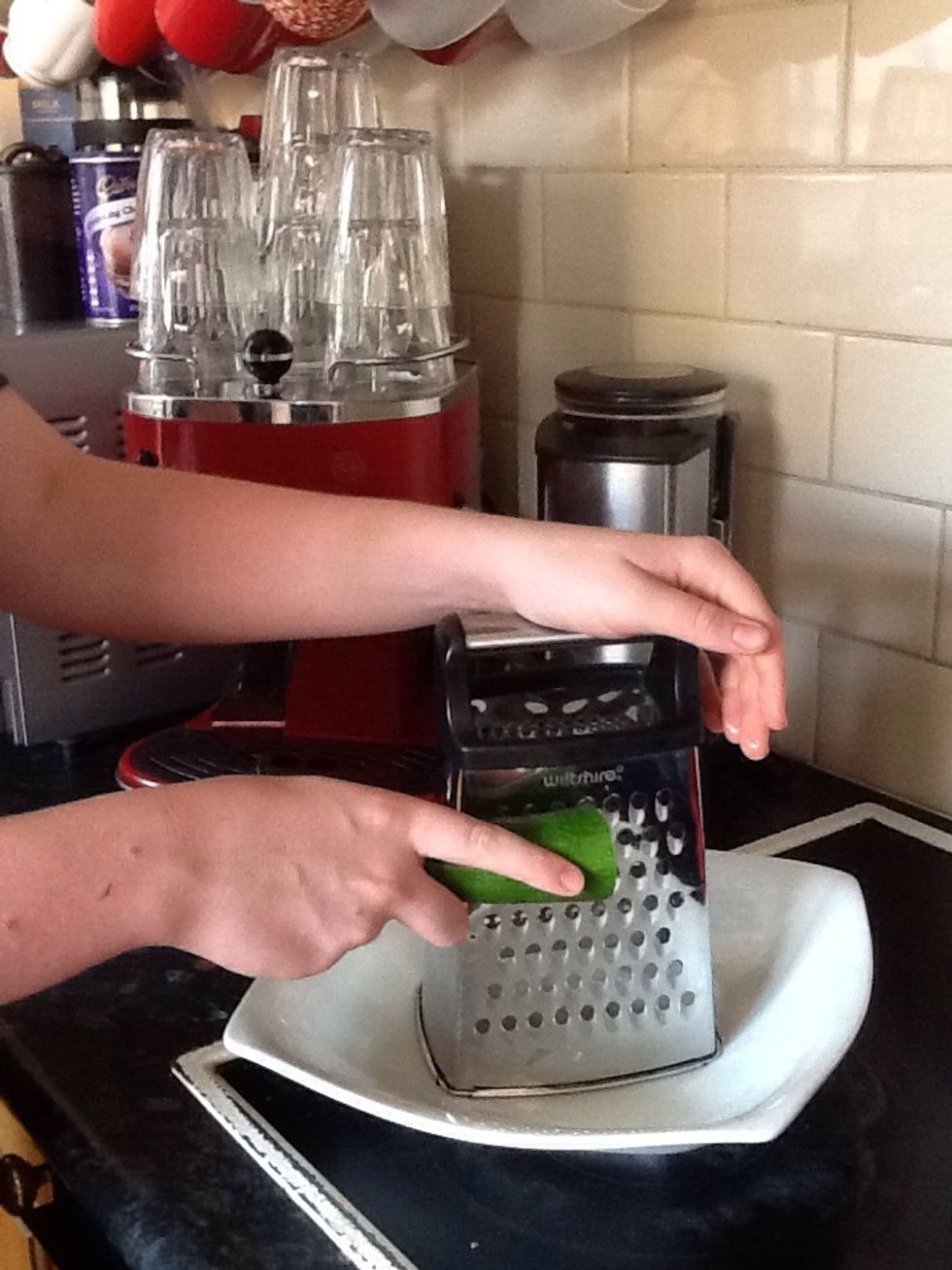 Next, you must clean your zucchini before chopping off both ends and grating it. (I chopped my zucchini in half to make it easier to grate)