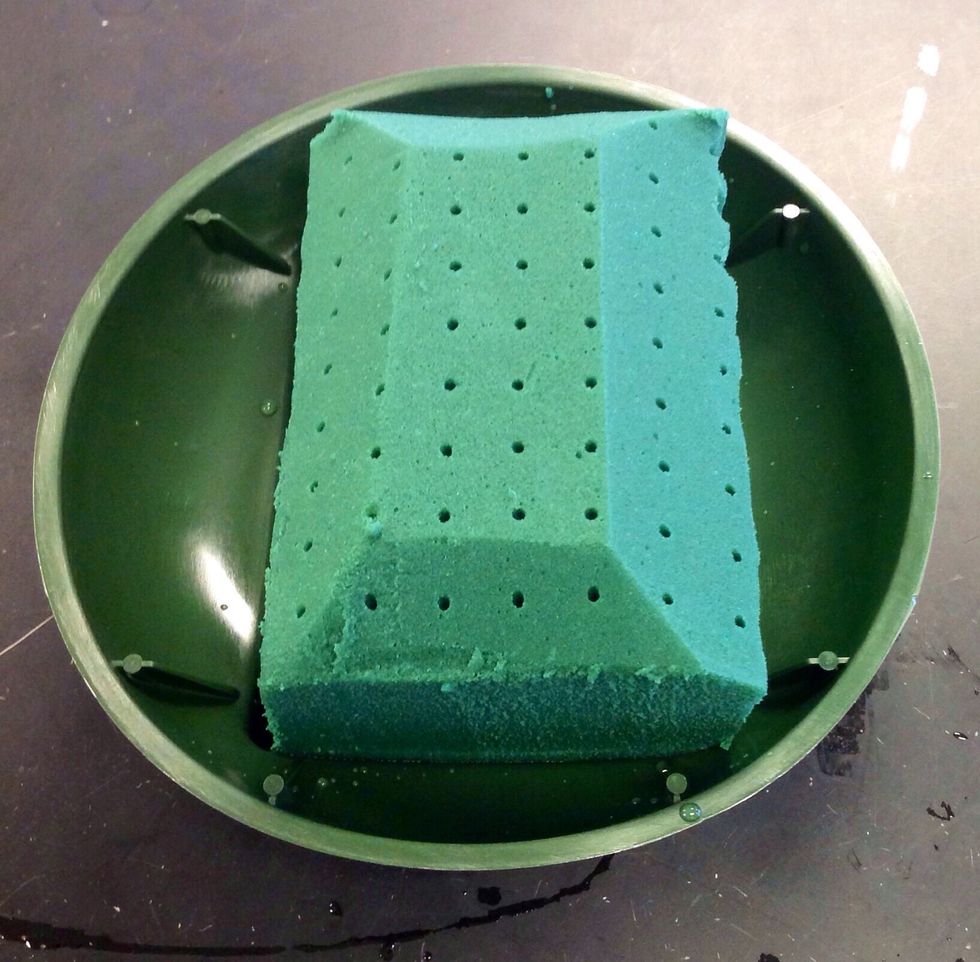 Next you must cut the edges off the oasis. This process is called beveling the edges. When you bevel the edges it doesn't have to be perfect and you do this to give the oasis more surface space.