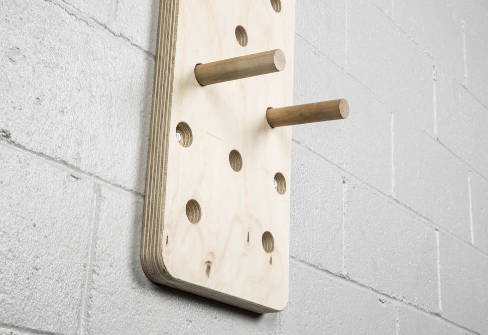 next you must put the pegs on the board with one hole in between.