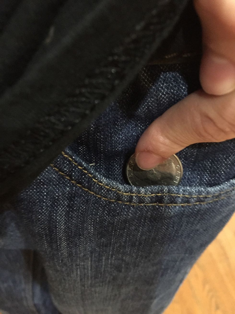 Next, you put the coin into your pocket. Don't get caught. Try to distract the audience with your other hand.
